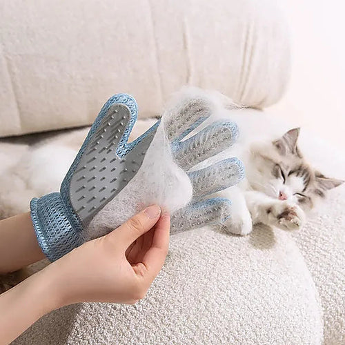 Grooming glove peeling a sheet of loose cat fur off, cat resting on a couch